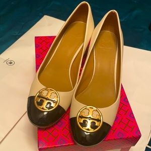 Tory Burch cream and patent leather heel with gold logo.
